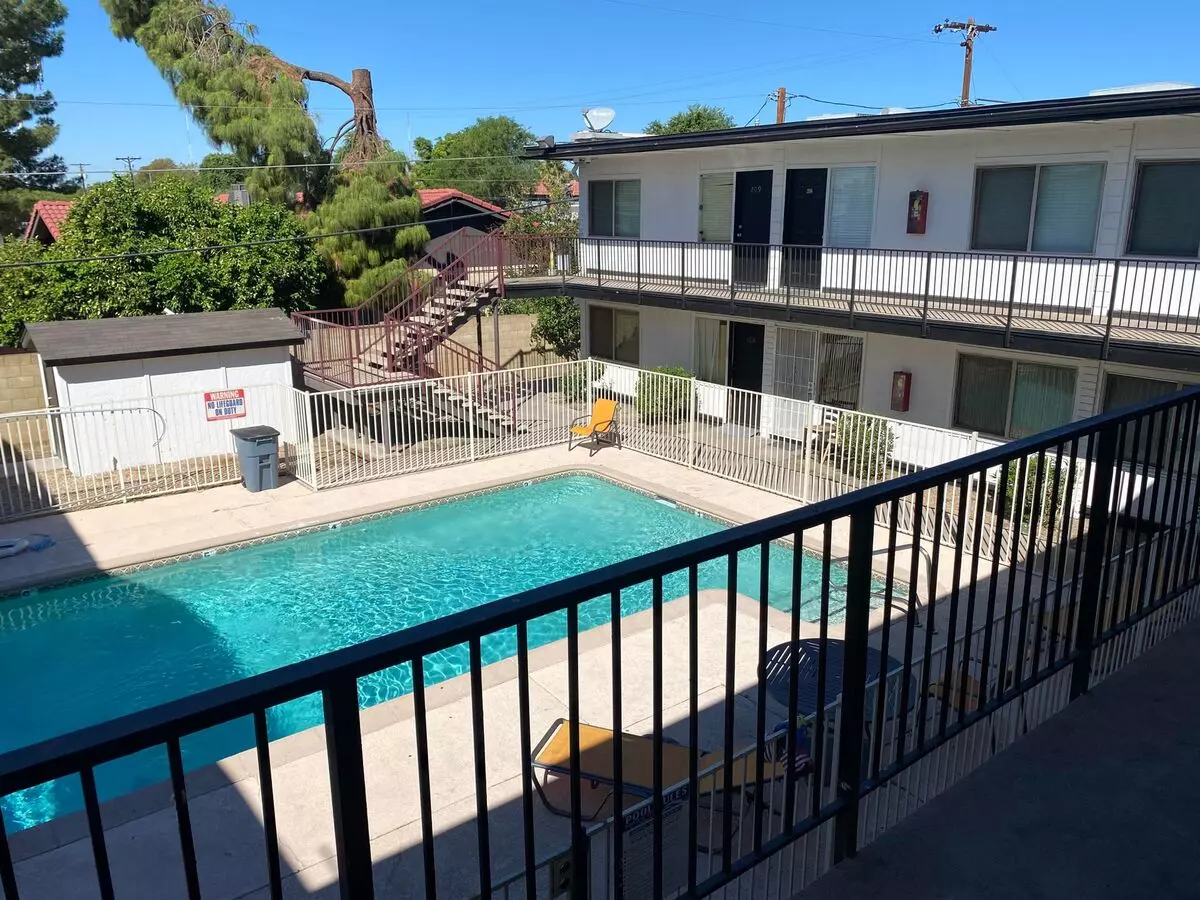 Pool and poolside area at Canyon Greens Apartments.